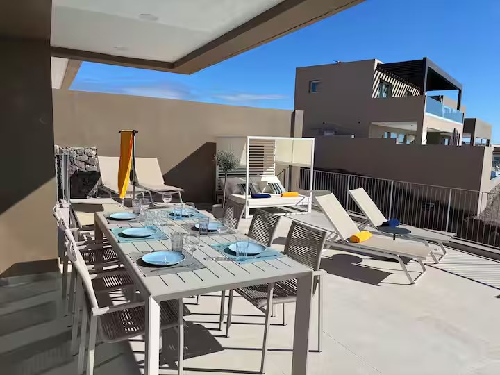 Outdoor dining table and sun loungers