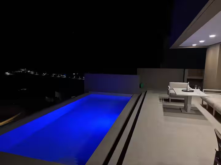 Private pool lit blue at night